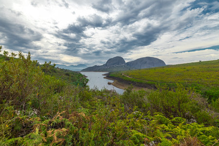 panorama of Paarl mountain nature reserve above the city of Paarl in South Africa. Cloudy day with visible lake and fynbos vegetation dominated by massive rounded granite rock formationsの写真素材