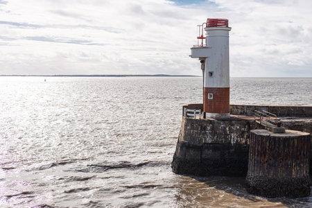 the Royan ferry terminal ramp extending towards a small lighthouse visible to the right.の写真素材