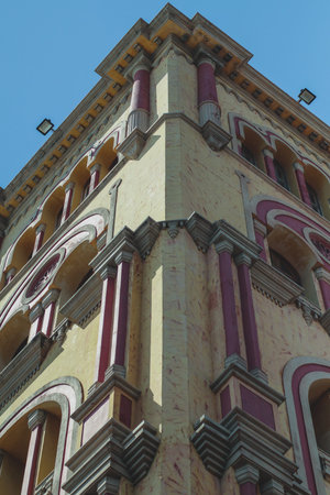 Low-angle view of a colorful historic building in Cartagena, Colombia, featuring ornate columns,...