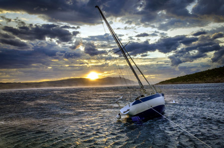 Moored sailboat in heavy winds