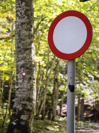 Same but different  All trafic forbidden sign versus right hiking trail mark in the background の写真素材