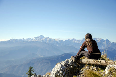 Young woman with a nice view over distant mountains 