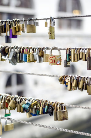 Groups of love keylocks hanging from wired fence.のeditorial素材