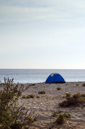 Tent camping on a lonely sandy beach.の写真素材
