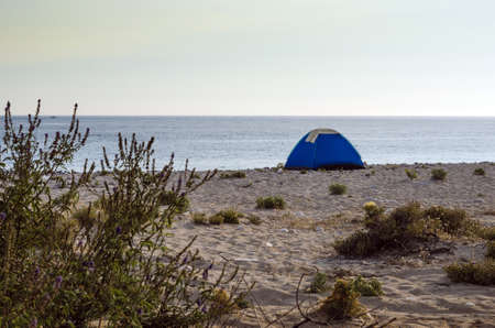 Tent camping on a lonely sandy beach.の写真素材