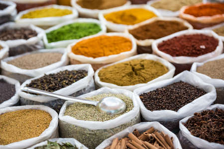 Indian spices in white sacks with scoop.の写真素材