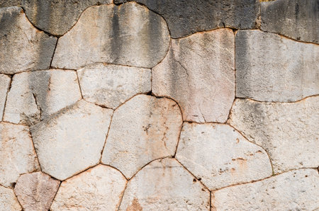 Weathered ancient greek stone wall cladding detail の写真素材