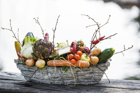 Basket full of mixed vegetable with white background.の写真素材