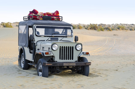 Old indian car stuck in sand and abandoned.のeditorial素材