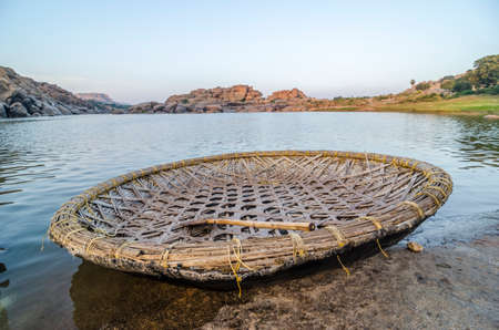 Traditional round boat on the shore of Tungabhadra river, Hampi, India.の写真素材