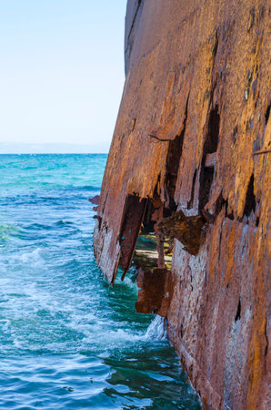 Broken rusted detail of a ship on the sea.の写真素材