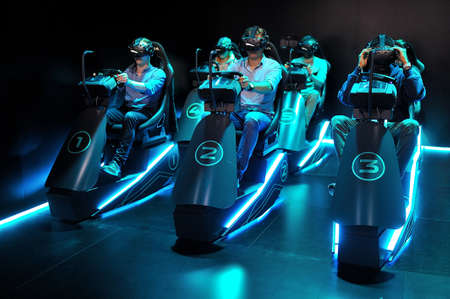 FRANKFURT, GERMANY - SEPT 2019: playing video games virtual reality glasses, IAA International Motor Show Auto Exhibtion.のeditorial素材