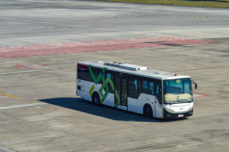An airport bus belonging to Angkasa Pura is taking passengers from the terminal to the plane on the apron of Juanda International Airport, Surabaya, Indonesia, 29 July 2023.のeditorial素材