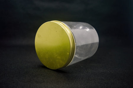 a minimalist plastic jar isolated on black backgroundの写真素材