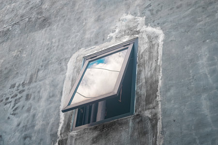 an open window on a concrete wallの写真素材