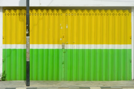 a yellow and green iron harmonica doorの写真素材