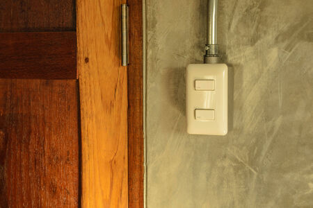 white plastic switch panel is on loft style wallの写真素材