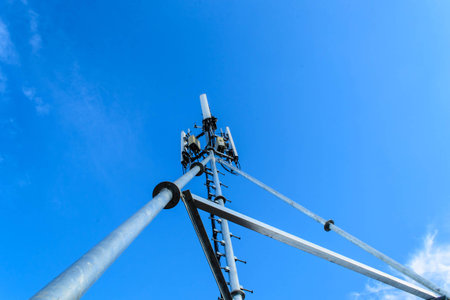 High mast metal structure telecommunication on tower with blue sky.の写真素材