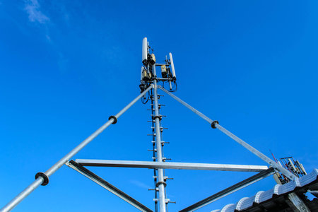 High mast metal structure telecommunication on tower with blue sky.の写真素材