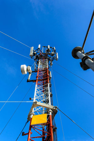 High mast metal structure telecommunication on tower with blue sky.