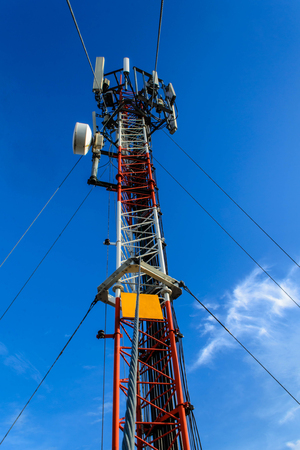 High mast metal structure telecommunication on tower with blue sky.の写真素材