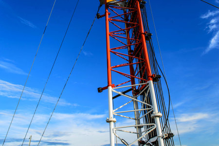 High mast metal structure telecommunication on tower with blue sky.の写真素材
