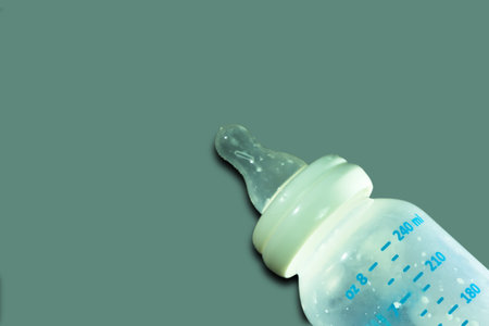 empty bottle of milk for baby on the gray background