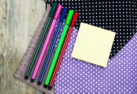 Color pencils and pen on wooden table see on top view.の写真素材