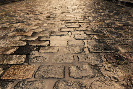 Wet cobbled street on sunset on a rainy day in Buenos Airesの写真素材