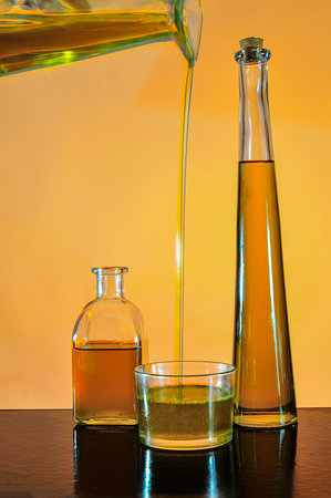Bottles of virgin olive oil, with colored background.の写真素材