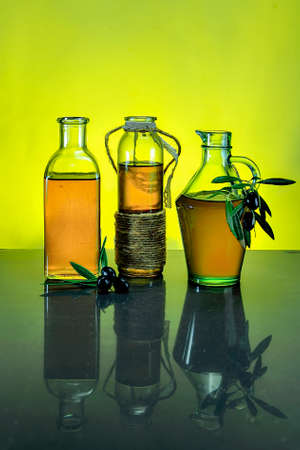 Bottles of virgin olive oil, with colored background.の写真素材
