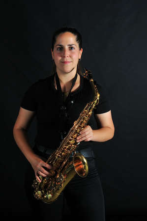 Young girl plays jazz music on saxophoneの写真素材