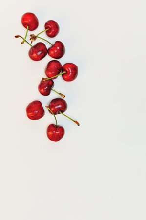 Red cherries, on white background, top view.の写真素材