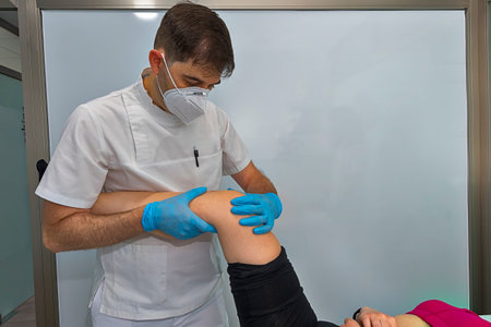Physician working on examining a girls injured foot