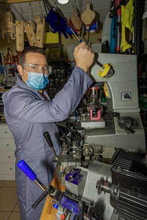 locksmith in workshop makes new keyの写真素材