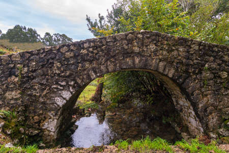 Medieval bridge in Cuerres de Asturiasの写真素材