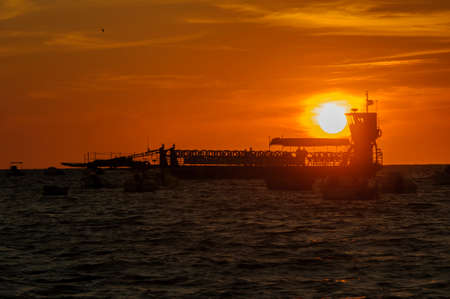 Sunset behind the river fishing boats.の写真素材