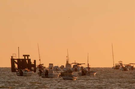Sunset behind the river fishing boats.の写真素材