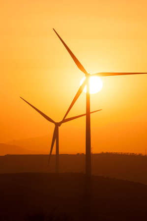 Magnificent sunset behind the wind turbinesの写真素材