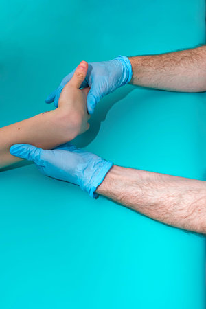 Physician working on examining a girls injured hand