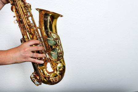 Hands of a saxophonist on a white background