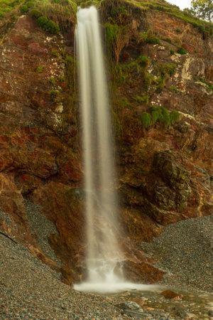 Waterfall in the mill on the beach of Vallina del Gallo