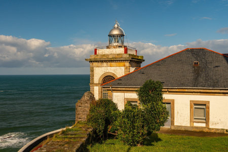 A lighthouse or light signaling tower located on the sea coast or on the mainland.