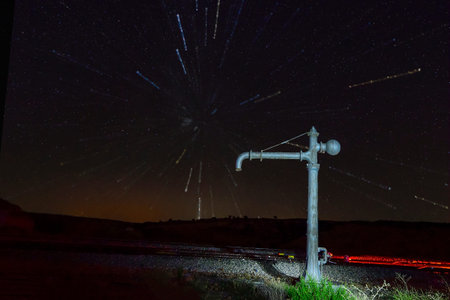 Night photography over the water fountain of the Alamedilla railway station.