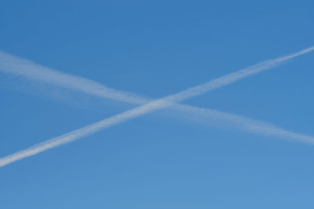Contrails - white lines against the blue sky.