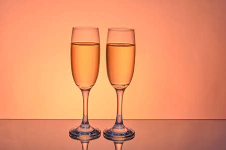 Two wine glasses isolated on color background.の写真素材