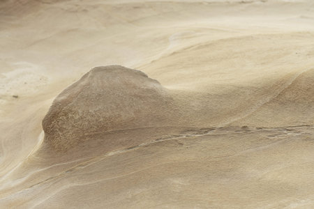 Close-up of a smooth sandstone surface featuring gentle erosion patterns and subtle textures. Ideal...