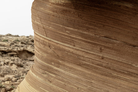Detailed close-up of a weathered sandstone rock formation showing natural textures and layers. Ideal...