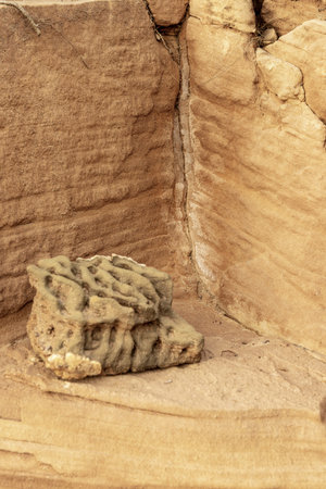 Close-up of a weathered sandstone corner featuring distinct erosion layers and natural textures....