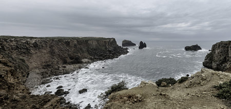 Scenic view of the rugged cliffs and the Atlantic Ocean at Cabo San Vicente, Portugal. The unique...